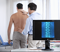 Kinesiologist analyzing a patients back.